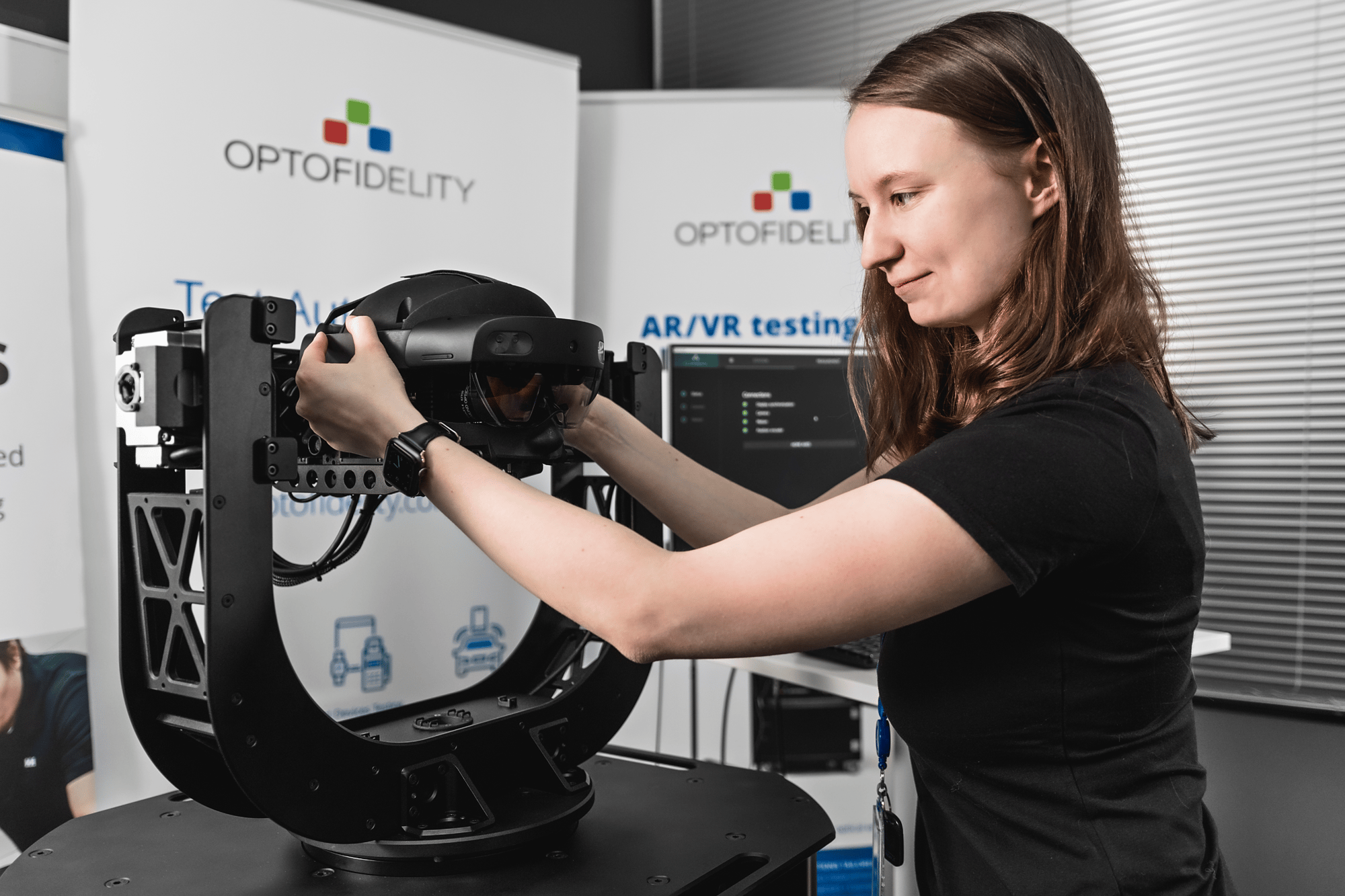 A woman working with the OptoFidelity BUDDY temporal tester